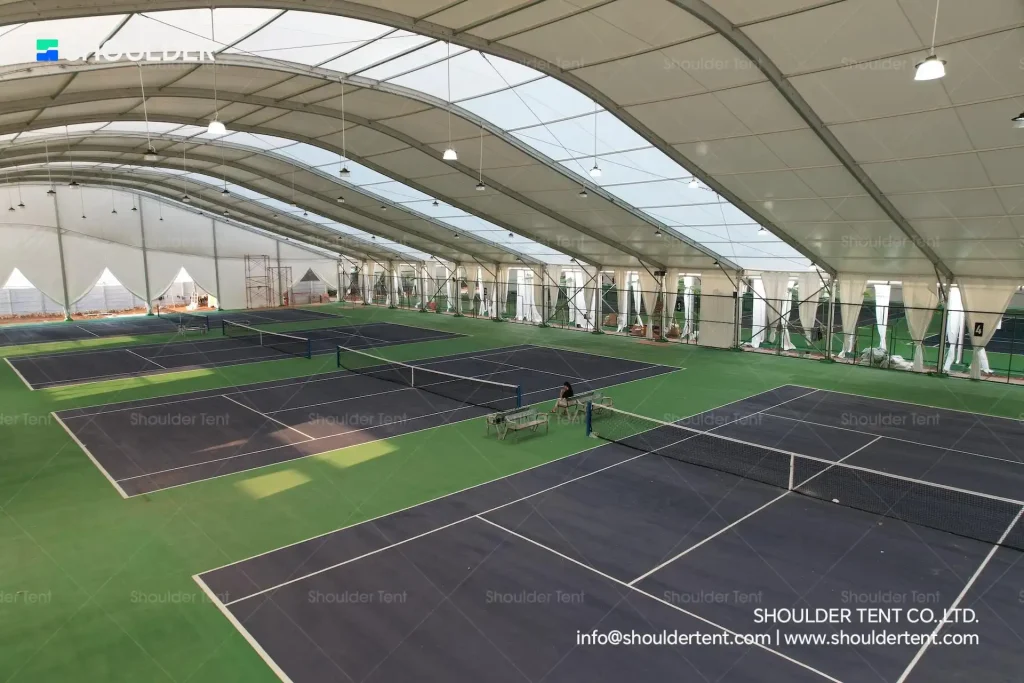 Aerial interior view of a massive clear span aluminum structure covering tennis courts