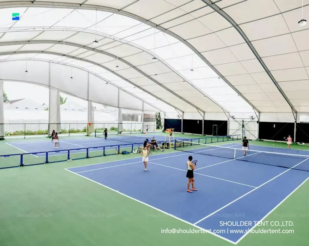 Well-ventilated indoor tennis facility housed in a modular aluminum structure.